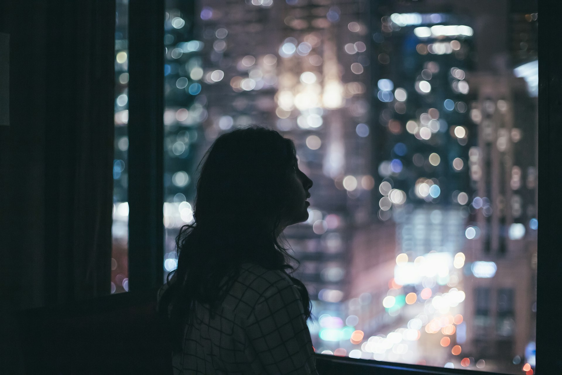 woman facing clear window